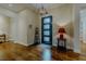 Inviting foyer featuring wood floors, front door, and neutral decor at 11477 Timber Mountain Ave, Las Vegas, NV 89135