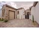 Exterior side-view of garage, featuring brick accents and a paver driveway at 11477 Timber Mountain Ave, Las Vegas, NV 89135