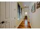 Inviting hallway featuring hardwood floors, neutral paint, and access to other rooms at 11477 Timber Mountain Ave, Las Vegas, NV 89135