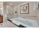 The bathroom features a soaking tub and glass-enclosed shower with upgraded finishes at 125 E Harmon Ave # 3220, Las Vegas, NV 89109