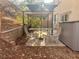 Outdoor patio space with a dining set, umbrella, and storage shed at 1463 Evening Song Ave, Henderson, NV 89012