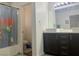 Bathroom featuring double sinks and a shower with a colorful curtain and commode at 1463 Evening Song Ave, Henderson, NV 89012