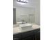 Bathroom featuring a rectangle sink with a large mirror, and dark wood cabinetry at 1463 Evening Song Ave, Henderson, NV 89012