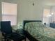 Comfortable bedroom featuring a bed, accent chair, and natural light at 1463 Evening Song Ave, Henderson, NV 89012