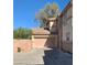 Beige two-story home featuring an attached two-car garage, offering convenient parking and storage at 1463 Evening Song Ave, Henderson, NV 89012