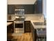 Modern kitchen features stainless steel appliances and dark wood cabinetry with light countertop at 1463 Evening Song Ave, Henderson, NV 89012