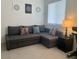 Inviting living room with a gray sectional, geometric wall art and comfortable lighting at 1463 Evening Song Ave, Henderson, NV 89012