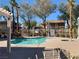 Community pool with surrounding palm trees, offering a luxurious recreational space for residents at 1463 Evening Song Ave, Henderson, NV 89012