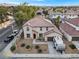 Aerial view of a two-story home with a tile roof, two-car garage, and manicured, low-water landscaping at 1495 Le Luberon Ct, Las Vegas, NV 89123