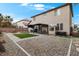 Spacious backyard featuring a pergola, artificial turf, and low-maintenance desert landscaping at 1495 Le Luberon Ct, Las Vegas, NV 89123