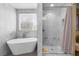 Bright bathroom with a luxurious standalone tub and a modern, glass-enclosed shower at 1495 Le Luberon Ct, Las Vegas, NV 89123