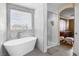 Bright bathroom featuring a modern tub, walk-in shower, and contemporary design at 1495 Le Luberon Ct, Las Vegas, NV 89123