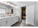 Modern bathroom featuring a double vanity and walk-in closet for extra storage and convenience at 1495 Le Luberon Ct, Las Vegas, NV 89123