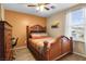 Cozy bedroom with wooden furniture, comfortable bedding, and natural light from the window at 1495 Le Luberon Ct, Las Vegas, NV 89123