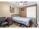 Bedroom with ceiling fan, natural light, wooden floors, and space for decor at 1495 Le Luberon Ct, Las Vegas, NV 89123