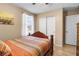 Bedroom with natural light, wooden floors, and a closet with sliding doors at 1495 Le Luberon Ct, Las Vegas, NV 89123