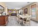 Inviting dining area with granite table, view to living room and natural light from nearby door at 1495 Le Luberon Ct, Las Vegas, NV 89123