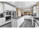 Open kitchen with granite island, stainless appliances, and breakfast bar at 1495 Le Luberon Ct, Las Vegas, NV 89123