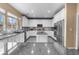 Modern kitchen with white cabinets, stainless appliances, and granite counters at 1495 Le Luberon Ct, Las Vegas, NV 89123