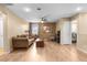 Well-lit living room with a ceiling fan, comfortable seating, and adjacent access to a bedroom at 1495 Le Luberon Ct, Las Vegas, NV 89123