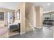 Open-concept living area with stairs, tile flooring, a comfortable sofa, and large windows for natural light at 1495 Le Luberon Ct, Las Vegas, NV 89123