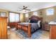 Elegant main bedroom with ample natural light, a ceiling fan and wooden furniture at 1495 Le Luberon Ct, Las Vegas, NV 89123