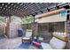 Spacious backyard patio area with chairs, a pergola, brick accents, and a grill at 1839 Avacado Ct, Henderson, NV 89014