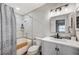 Clean bathroom featuring a bathtub, shower, toilet, vanity, mirror, and decorative light fixture at 1839 Avacado Ct, Henderson, NV 89014