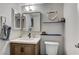 This bathroom features a vanity with a sink, a toilet, a mirror, and decorative accents at 1839 Avacado Ct, Henderson, NV 89014