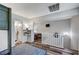 Bright upstairs area with hardwood floors, a bathroom and a bedroom that features a mounted television at 1839 Avacado Ct, Henderson, NV 89014