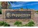 Stone sign welcomes you to the Peppertree Community with manicured landscaping and desert foliage at 1839 Avacado Ct, Henderson, NV 89014