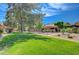 Well-maintained community grounds featuring lush green lawns, mature trees, and beautifully landscaped walkways at 1839 Avacado Ct, Henderson, NV 89014