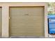 Single car garage door featuring the house number 1839 on a beige background at 1839 Avacado Ct, Henderson, NV 89014