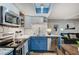 Bright kitchen features updated appliances, white cabinets, and a view of the living space at 1839 Avacado Ct, Henderson, NV 89014