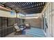 Cozy outdoor patio featuring a pergola, brick accent wall, and comfortable lounge seating for relaxation at 1839 Avacado Ct, Henderson, NV 89014
