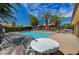 Community pool surrounded by lounge chairs and palm trees offers a relaxing oasis at 1839 Avacado Ct, Henderson, NV 89014