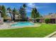 Scenic community pool with palm trees and green grass, providing a relaxing and enjoyable atmosphere at 1839 Avacado Ct, Henderson, NV 89014