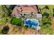 A beautiful home showcasing a pristine pool, manicured backyard, and lush landscaping from an aerial view at 19 Isleworth Dr, Henderson, NV 89052