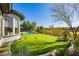 Backyard features putting green and pool with lush landscaping for a private outdoor experience at 19 Isleworth Dr, Henderson, NV 89052