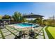 Relaxing backyard featuring pool, outdoor kitchen, and putting green for entertaining and recreation at 19 Isleworth Dr, Henderson, NV 89052