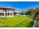 Expansive backyard with putting green, pool, and outdoor kitchen offers luxurious outdoor experience at 19 Isleworth Dr, Henderson, NV 89052