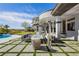 A beautiful backyard with a gorgeous pool, fire pit, outdoor seating area, and a covered patio at 19 Isleworth Dr, Henderson, NV 89052