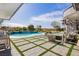 A serene backyard with a sparkling pool, fire pit, and outdoor lounge area perfect for relaxation and entertainment at 19 Isleworth Dr, Henderson, NV 89052