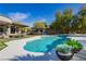 Incredible backyard with a stunning pool, outdoor bar, lush landscaping, and inviting patio area at 19 Isleworth Dr, Henderson, NV 89052