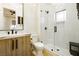 Chic bathroom with wood vanity, glass shower and modern fixtures at 19 Isleworth Dr, Henderson, NV 89052