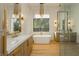 Luxury bathroom with a freestanding tub, double vanity, and a walk-in closet at 19 Isleworth Dr, Henderson, NV 89052