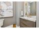 Elegant powder room showcasing marble countertop, gold fixtures, and contemporary design at 19 Isleworth Dr, Henderson, NV 89052