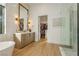 Elegant bathroom with a soaking tub, vanity, and access to a walk-in shower and closet at 19 Isleworth Dr, Henderson, NV 89052