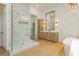 Bright bathroom features a large glass shower, modern vanity and soaking tub for a luxurious spa-like experience at 19 Isleworth Dr, Henderson, NV 89052