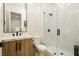 Stylish bathroom with a glass shower, modern fixtures, and sleek wood-look vanity at 19 Isleworth Dr, Henderson, NV 89052